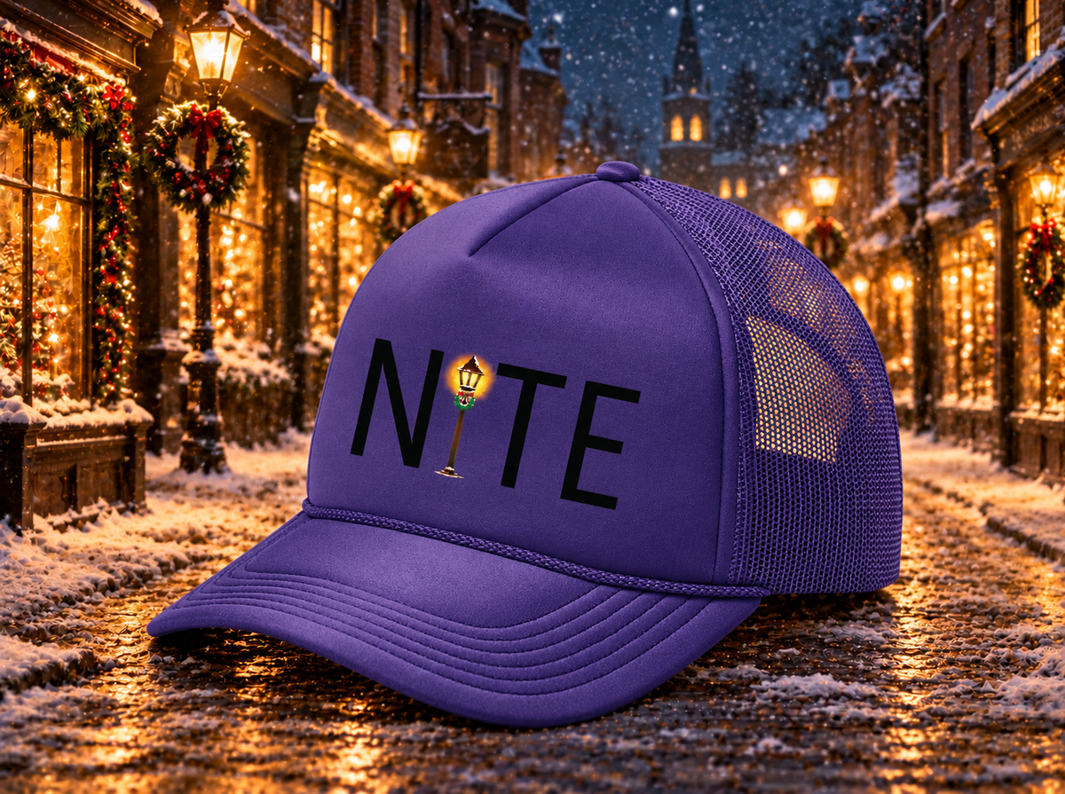 Purple foam trucker hat with the NITE theatre logo and a snowy holiday street background
