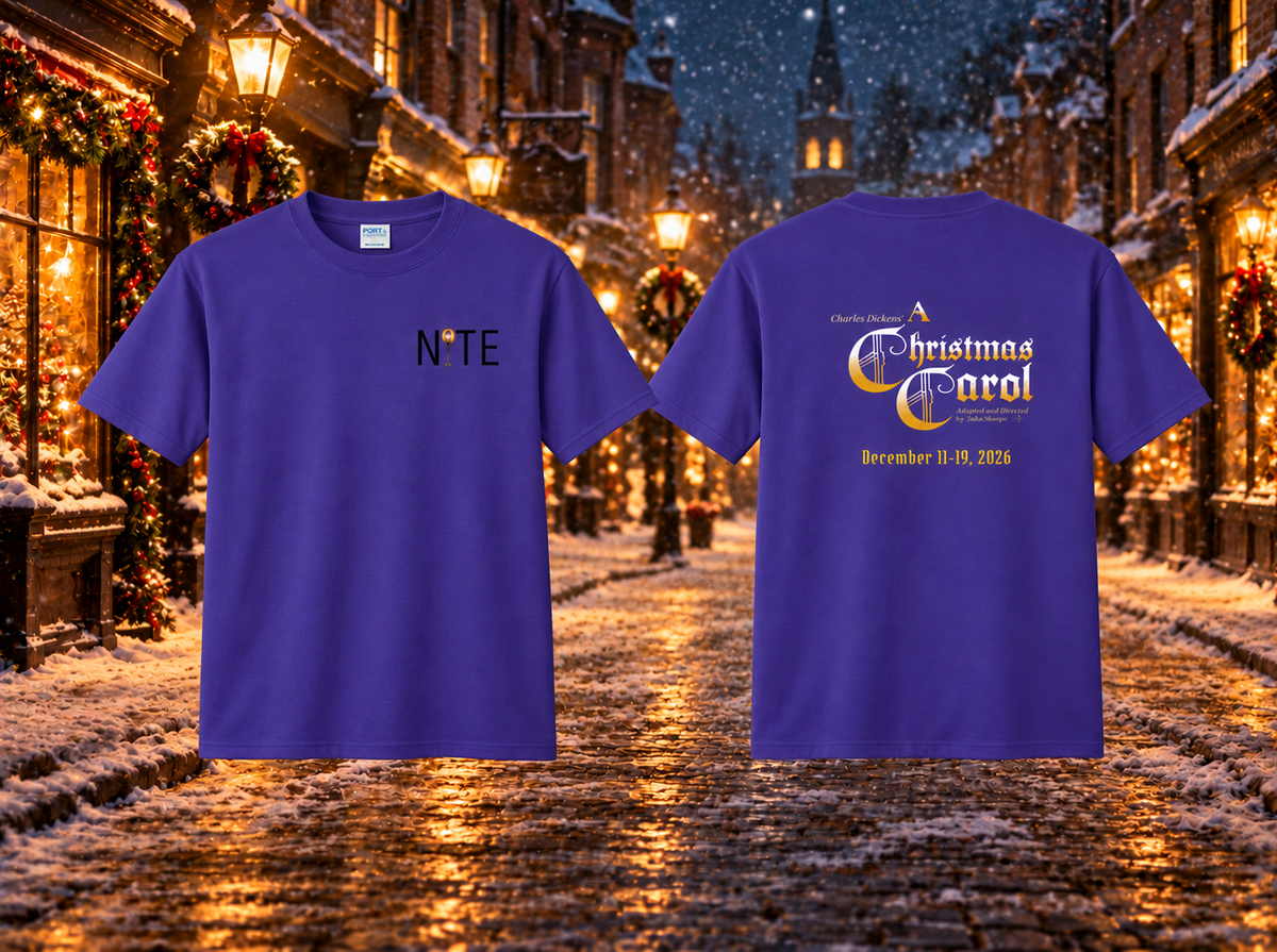 Purple t-shirt with the NITE theatre logo on the left chest and A Christmas Carol production logo on the back with a snowy holiday street in the back ground